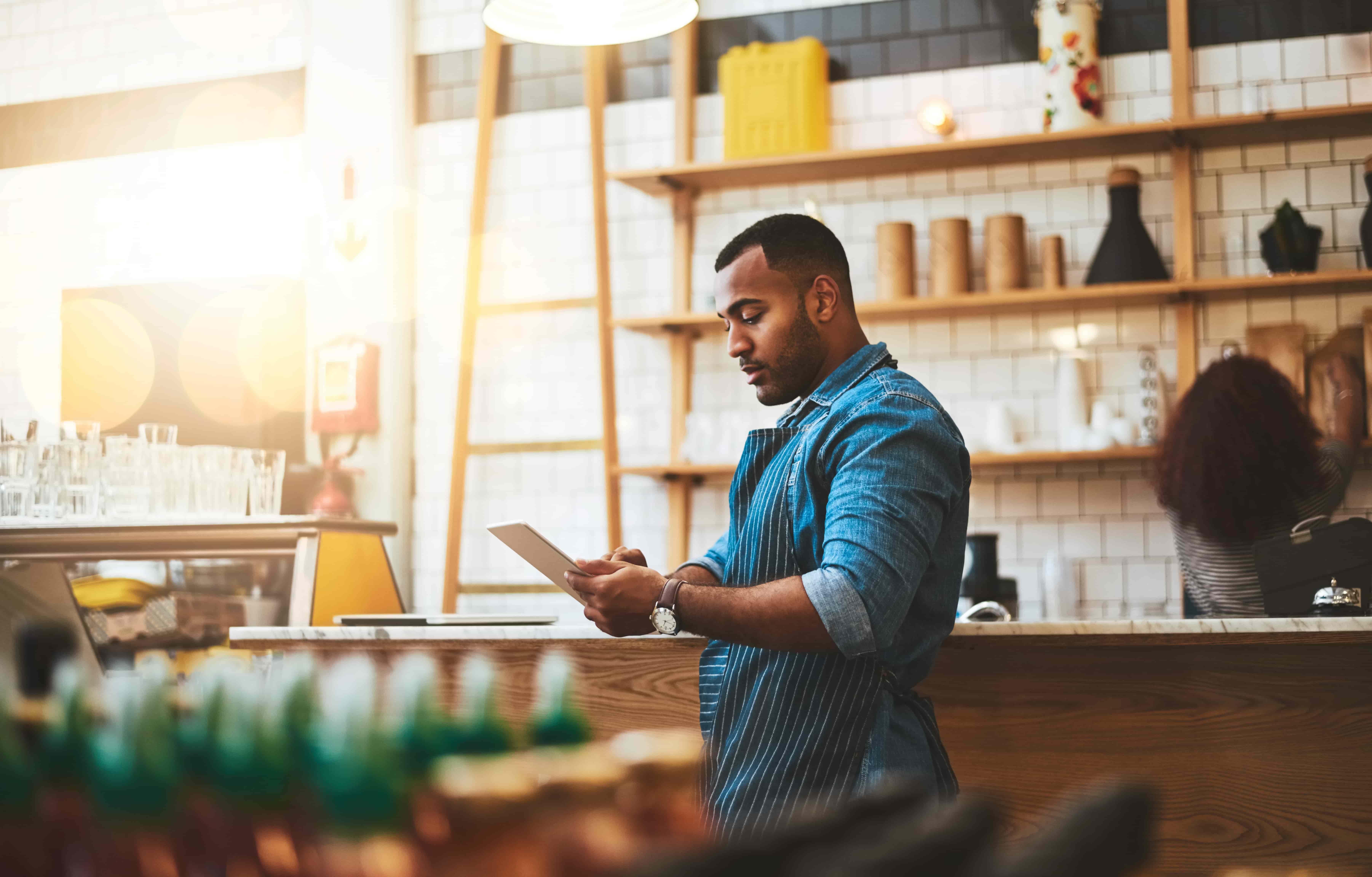 Man on tablet in restaurant