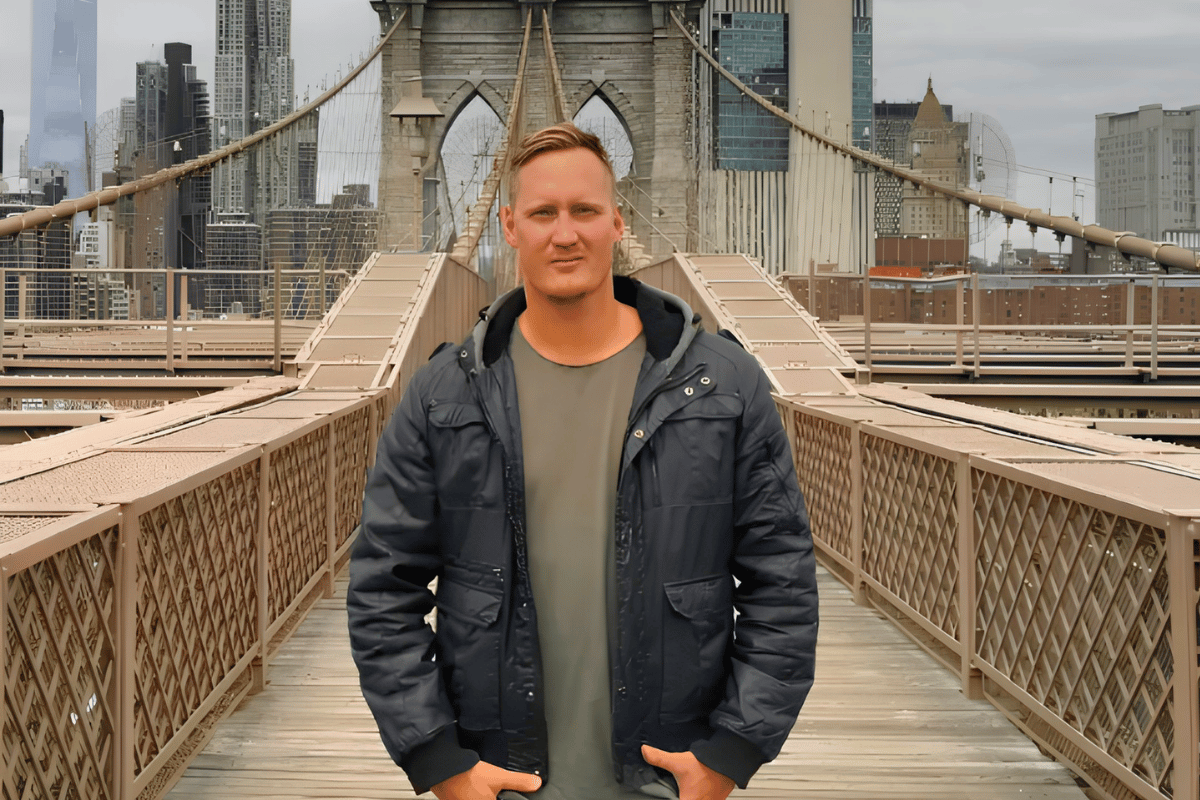 Man stood in middle of a bridge.