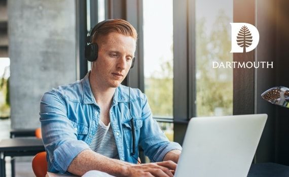 Man sitting at a laptop typing