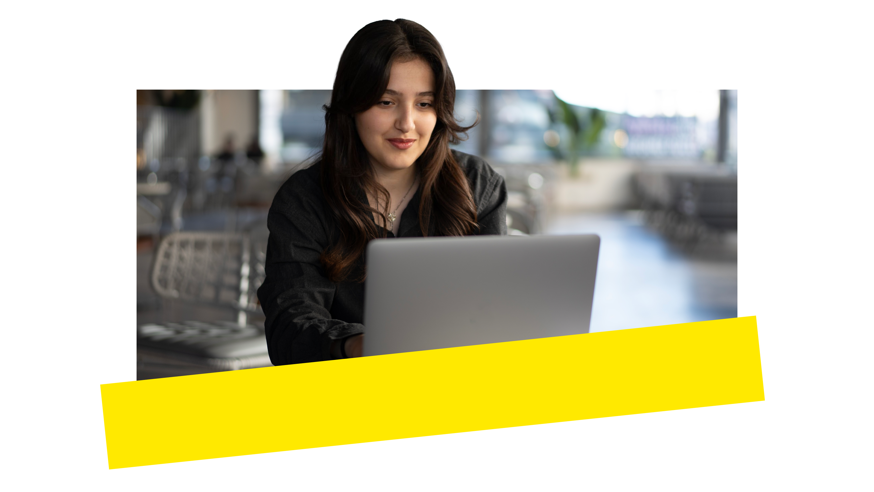 A person working on a laptop symbolizing AI-powered receptionist features that automate call answering, routing, and routine tasks