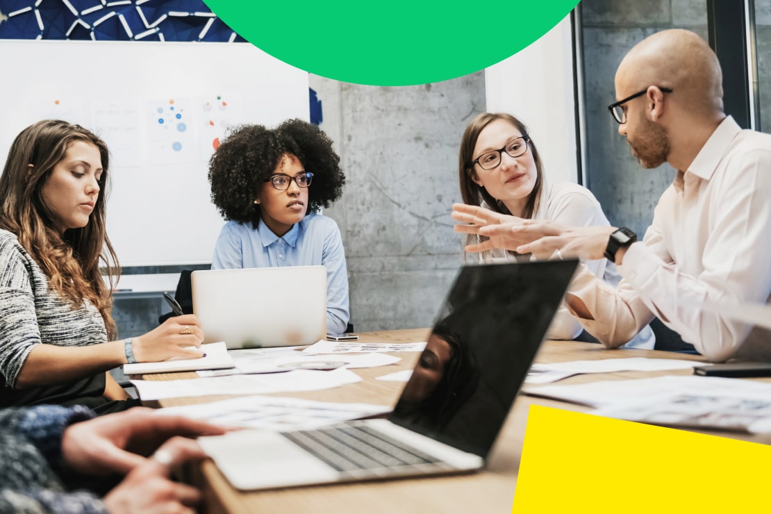 A group of employees discussing and collaborating using accurate, synced customer data to streamline operations and improve results.