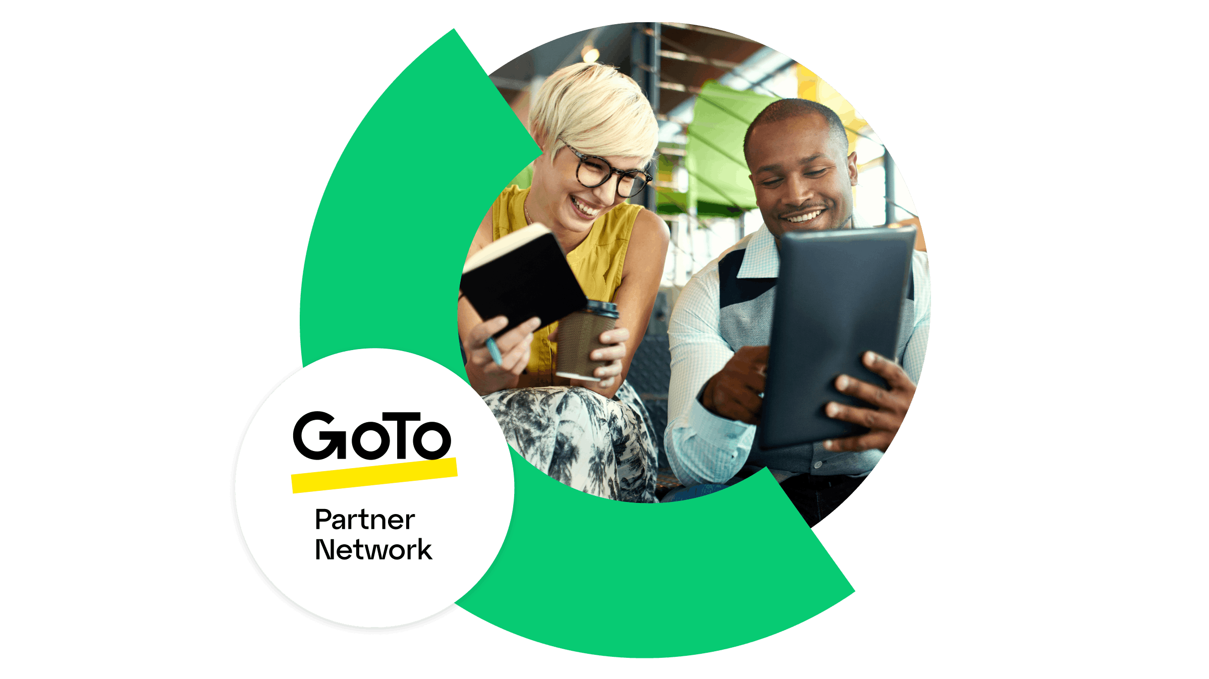 Two business professionals reviewing information together on a tablet, representing collaboration and growth through the GoTo Partner Network