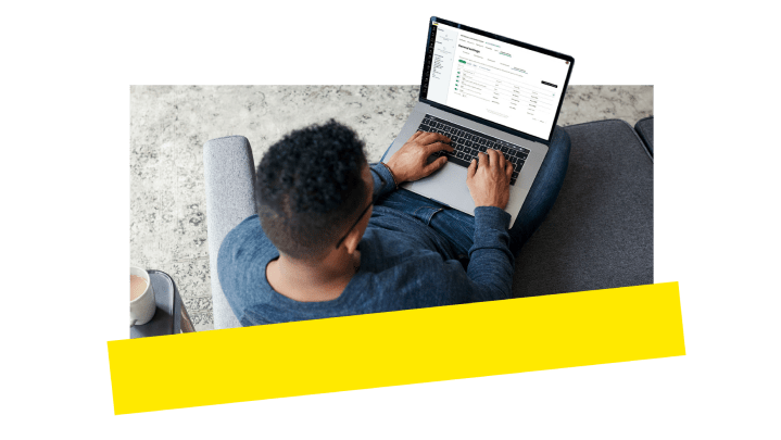 Man configuring GoTo Connect admin settings on his laptop.