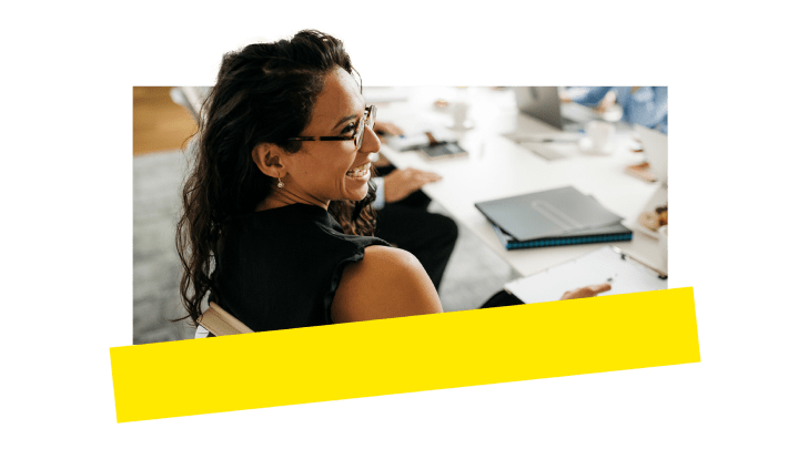 An employee enjoying herself while attending a call in a conference room.
