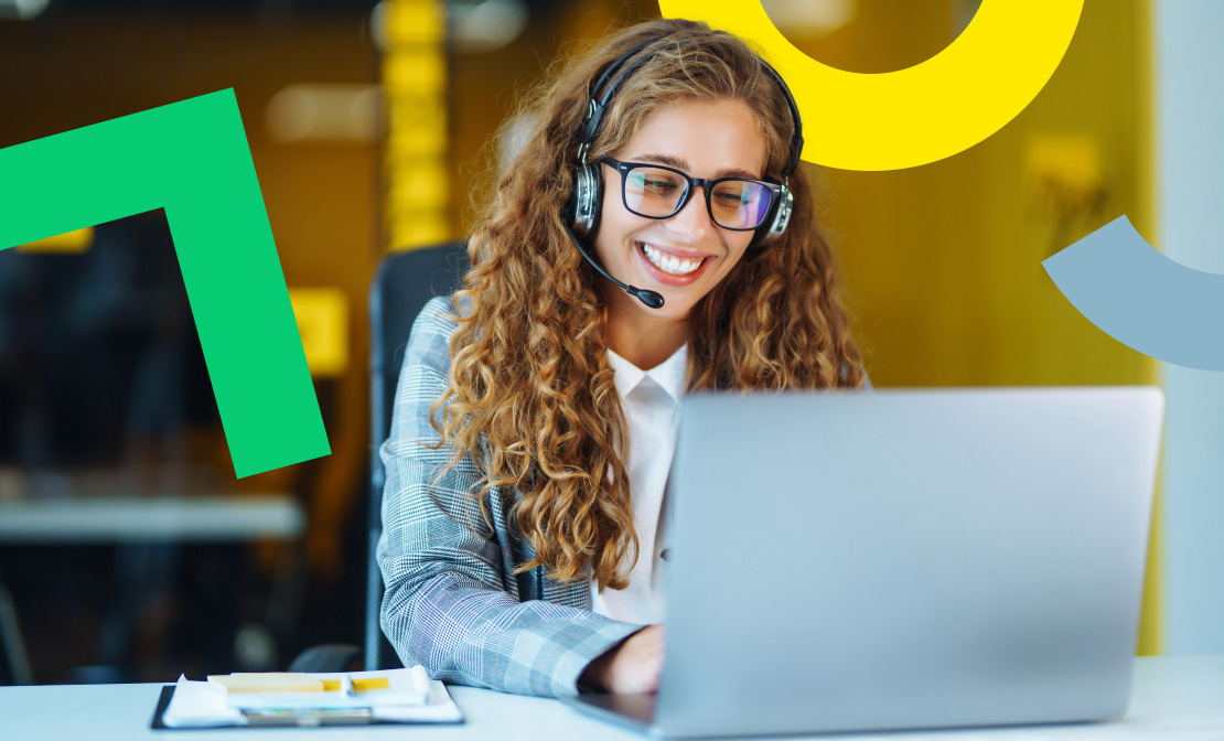 Personne avec un casque assise devant un ordinateur portable.