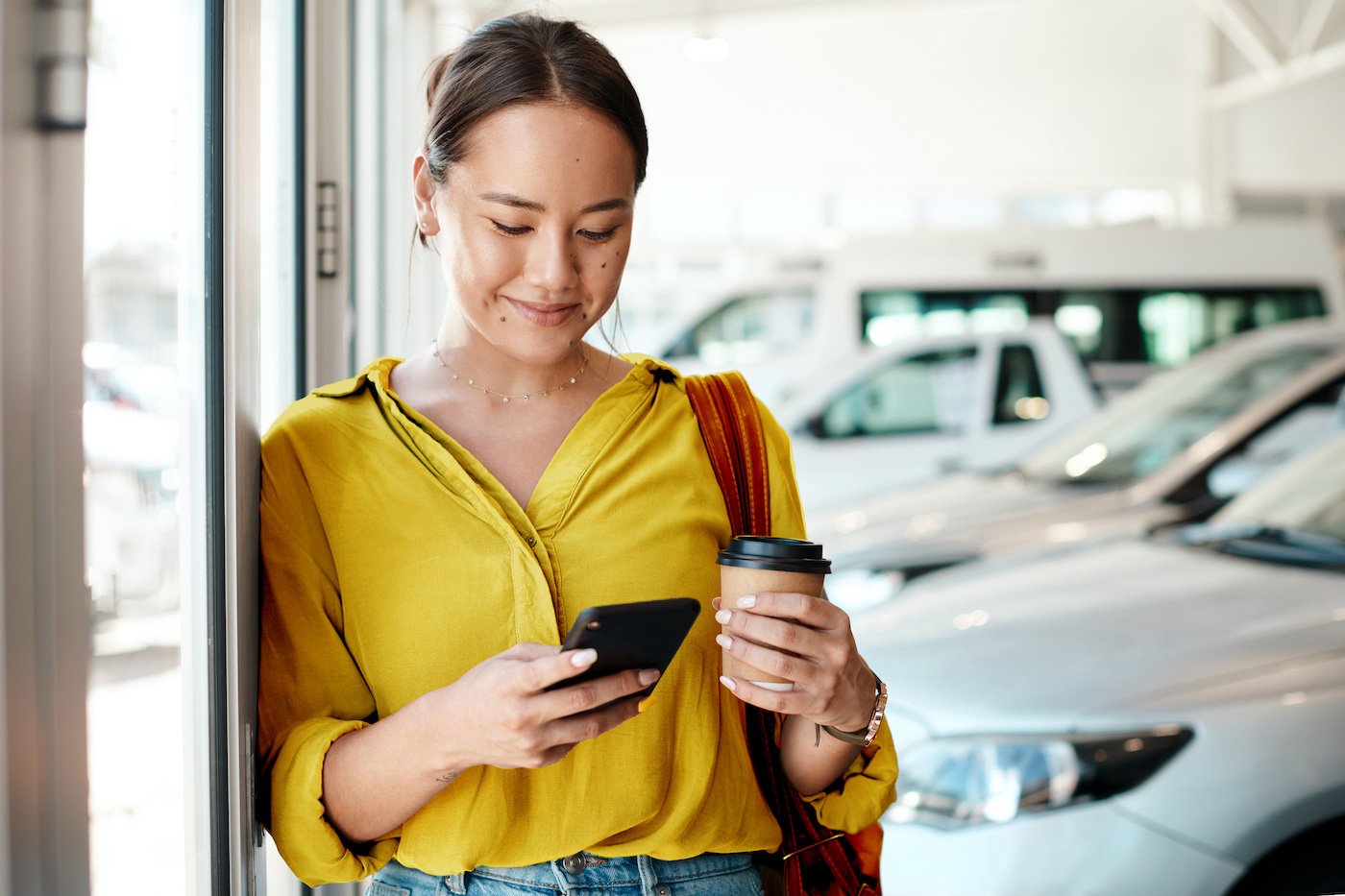 Professional using ticket management on her company's messaging app to answer employee questions on her mobile device.