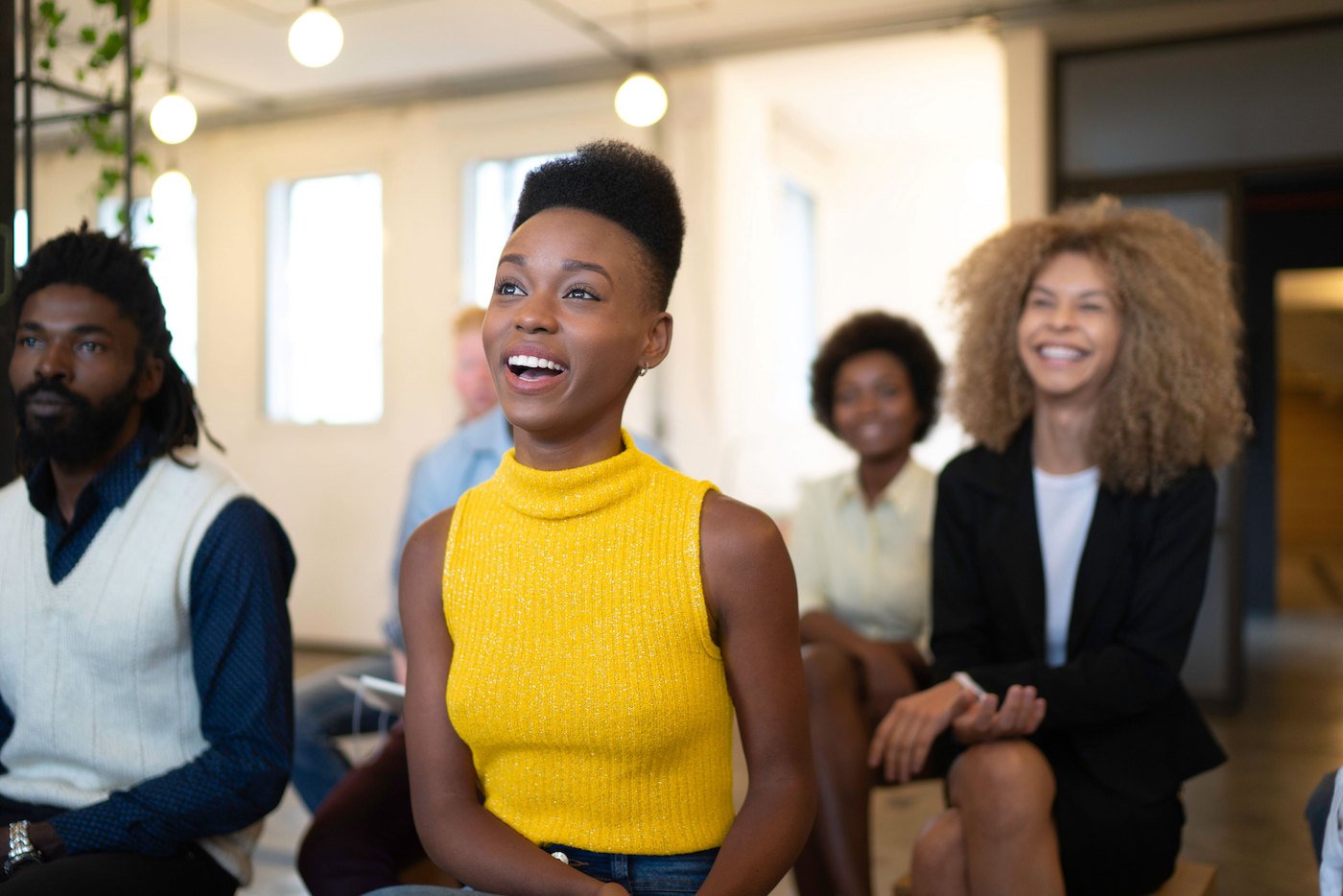 Small group of young professionals in a casual business setting learning marketing advice for MSPs