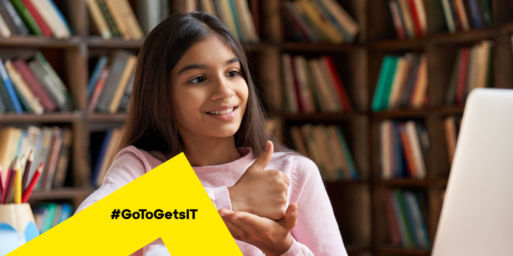 Student in a library learning sign language on a laptop, highlighting the need for remote IT support at schools and universities