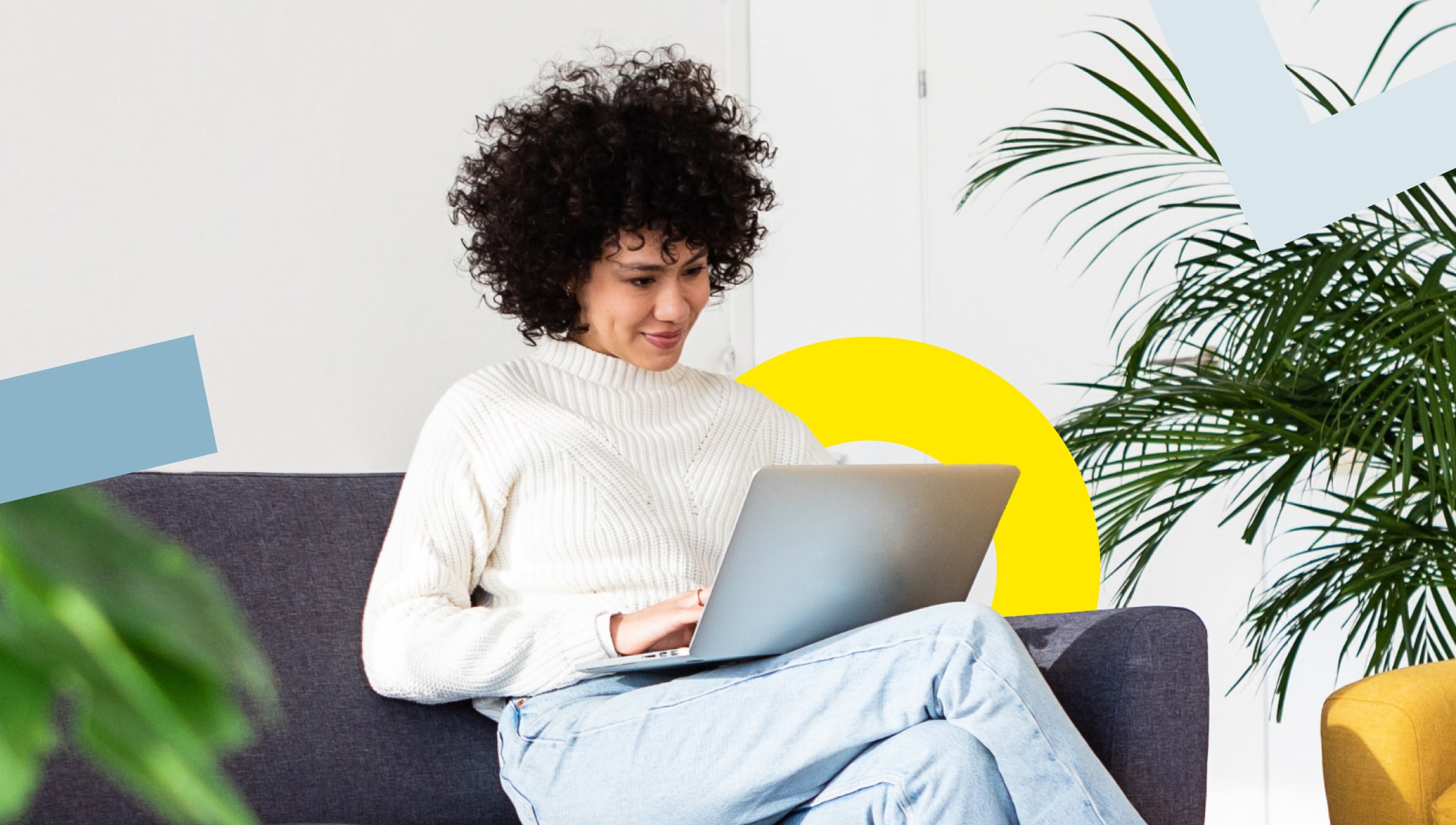 Person using a laptop on a sofa, looking satisfied with LogMeIn features.