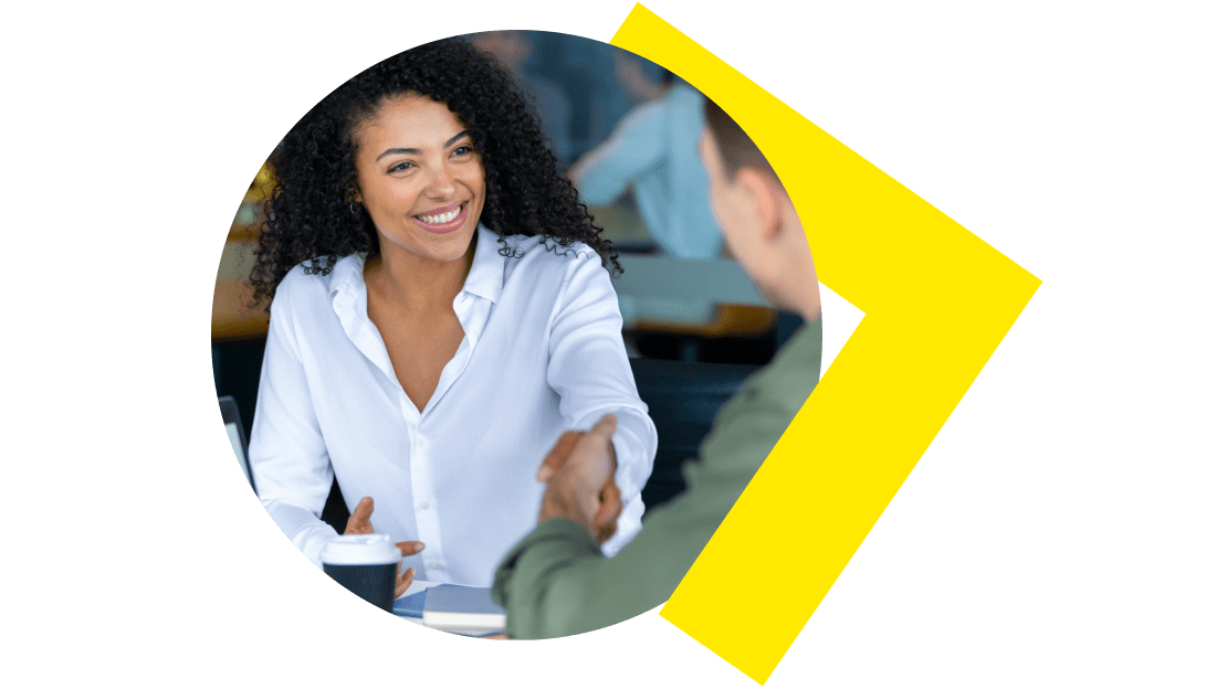 A business professional shaking hands during a meeting, symbolizing partnership and trust building in the LogMeIn Affiliate Program.