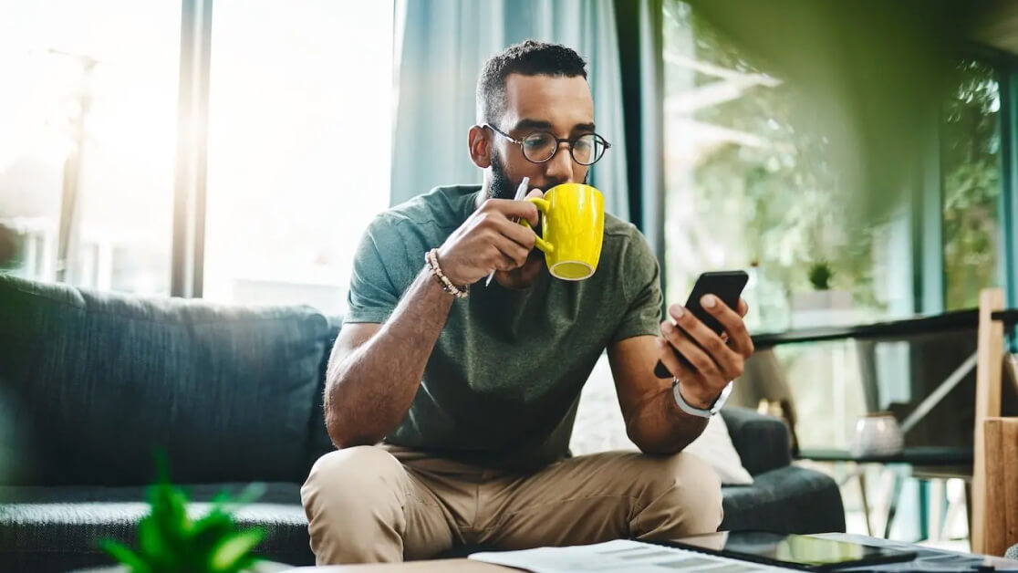 IT professional working remotely, securely managing devices using MDM solutions on a smartphone.