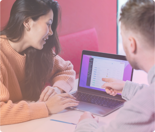 A pair of coworkers looking at a laptop screen