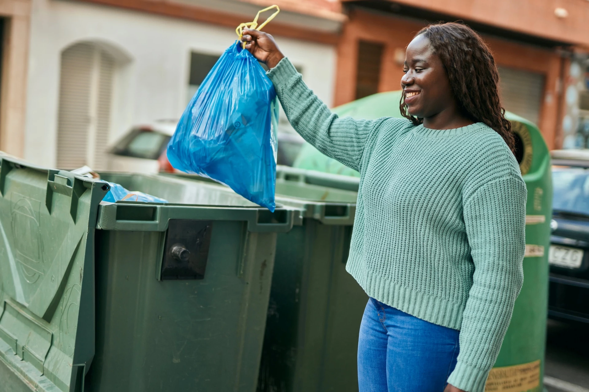 Girl taking out rubbish