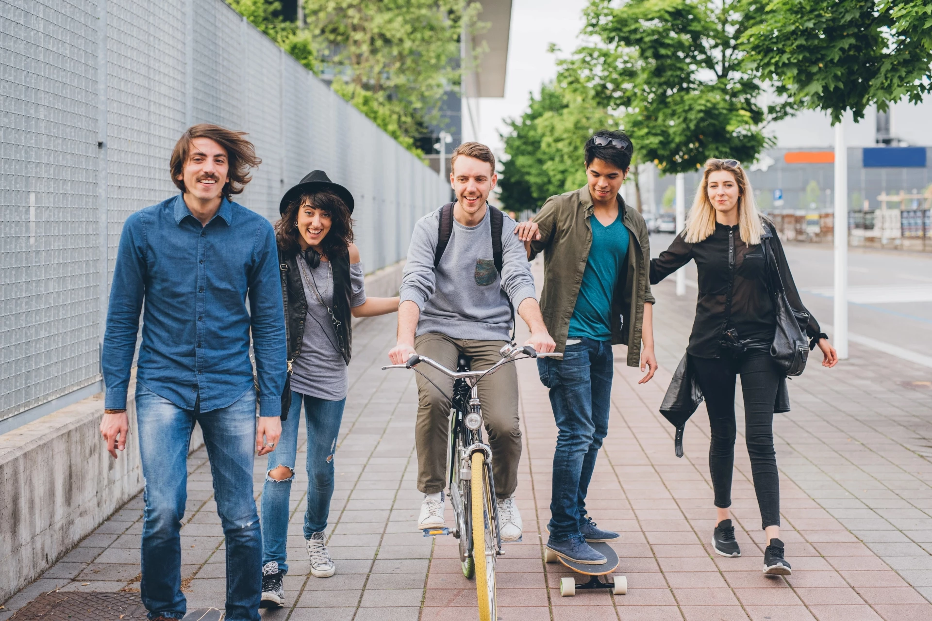Group of friends walking and cycling