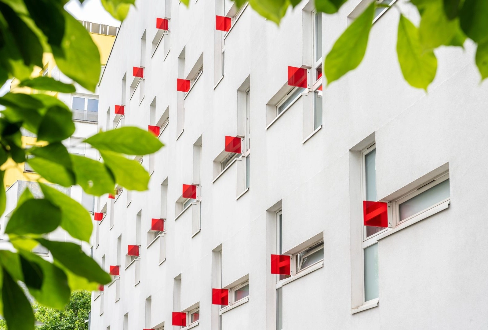 a white building with red square windows