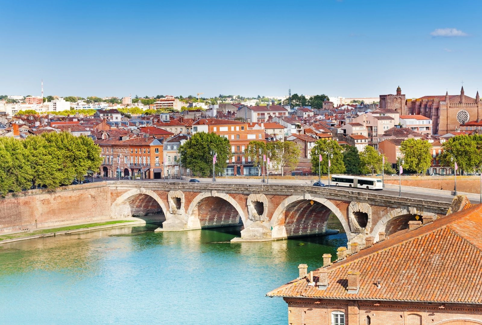 a bridge over a river with buildings in the background