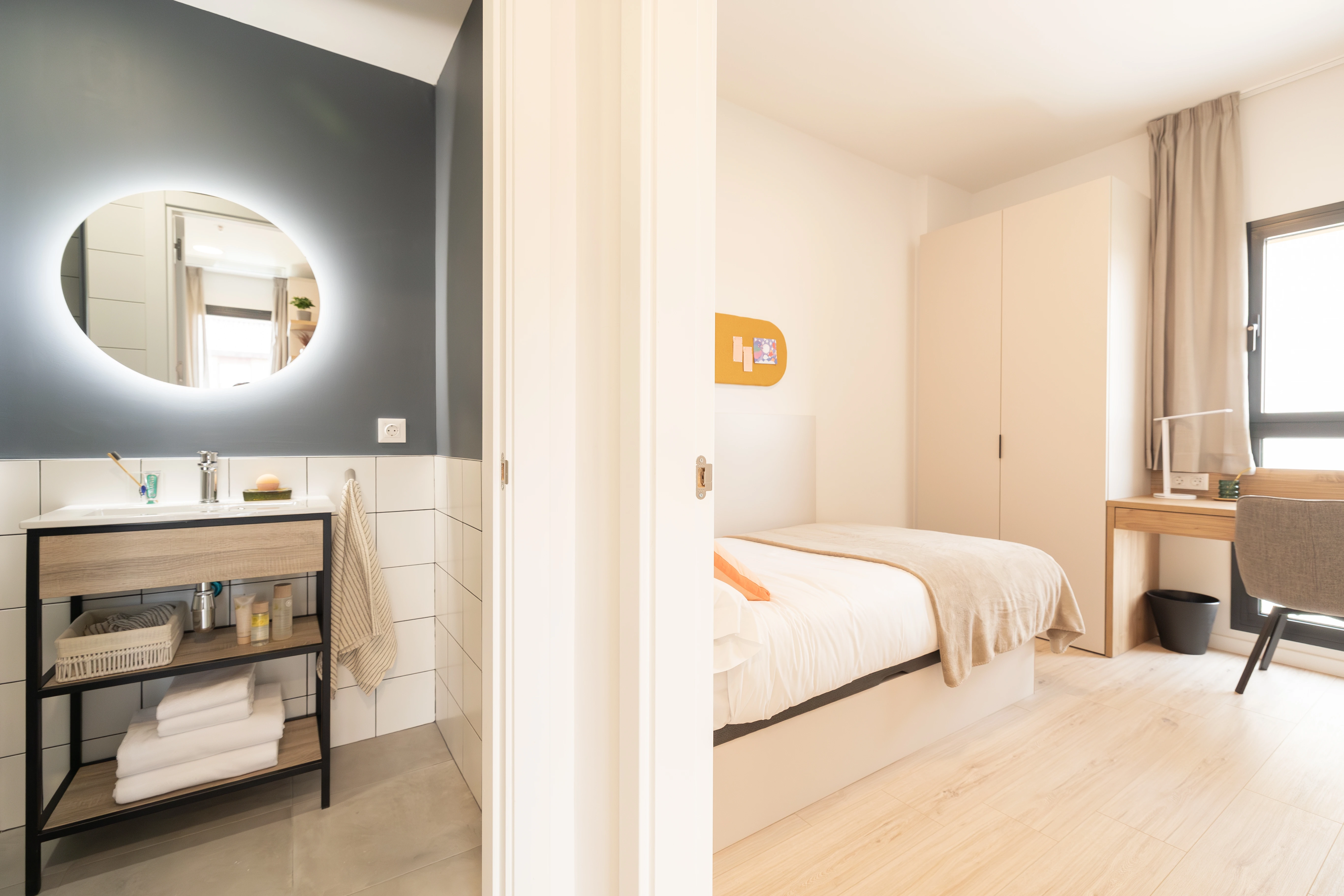 a bedroom with a mirror and a wood floor