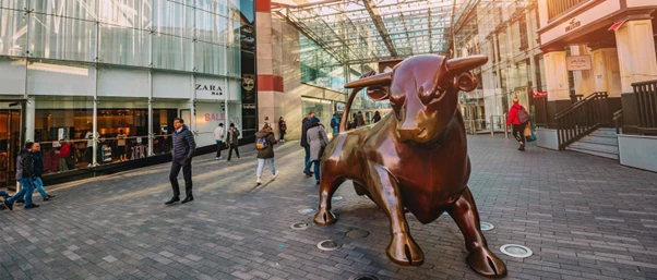 a statue of a bull in a city