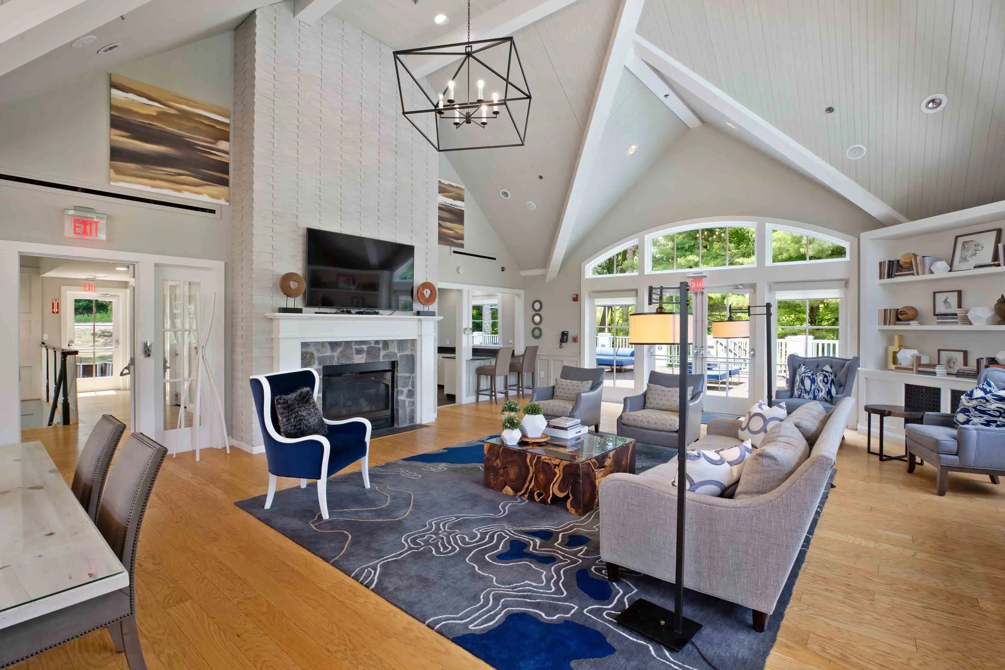 Elegant clubhouse with a cozy seating area, modern decor, and large windows at Avana Marlborough in Marlborough, MA.