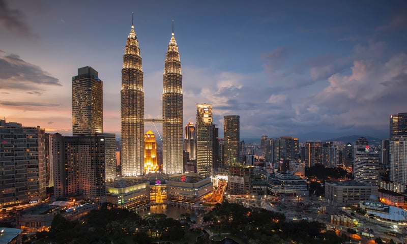 Brightly lit city center of Kuala Lumpur, at twilight