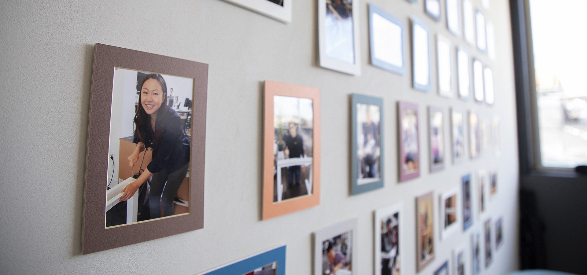 Wall gallery with images of people enjoying their work