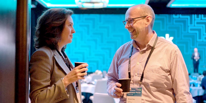 Man and woman in casual talk at a Guidewire event