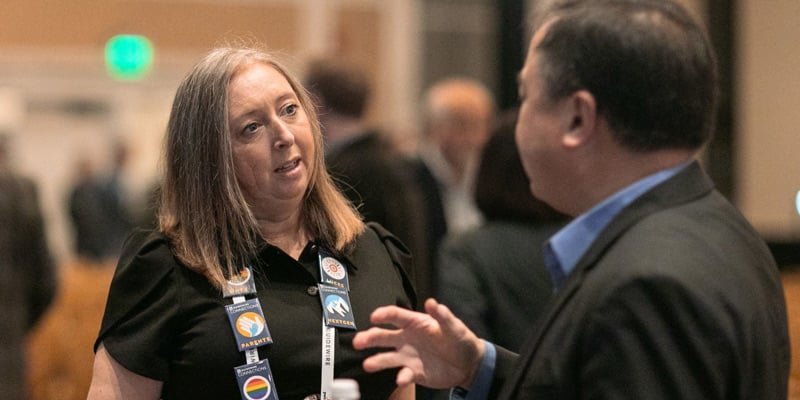 Two persons in discussion at an event