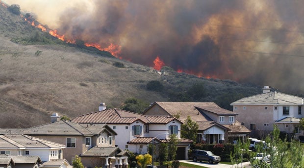 wildfire approaching a suburban neighborhood
