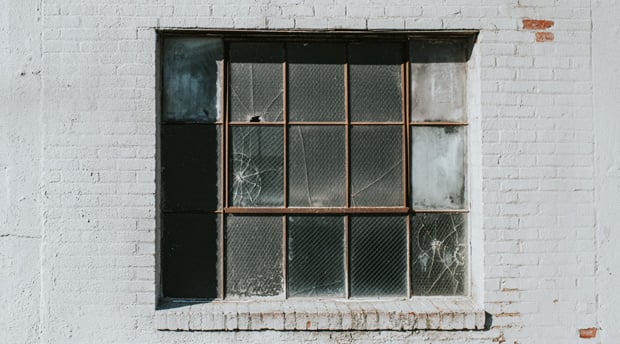 old, damaged windows in a commercial property building