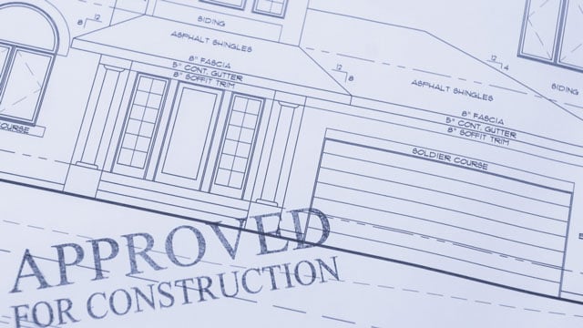 home blueprint with construction approval stamp