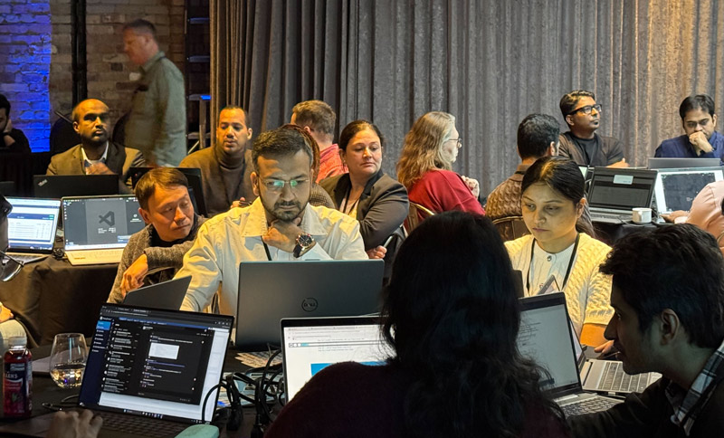 event room with group of attendees listening to a speaker