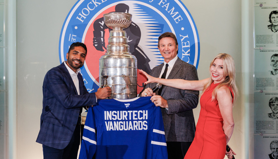 3 in front of trophy at Hockey Hall of Fame