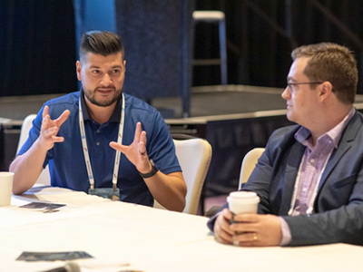 2 men at table having a discussion