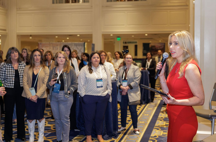 Laura Drabik speaks to reception attendees
