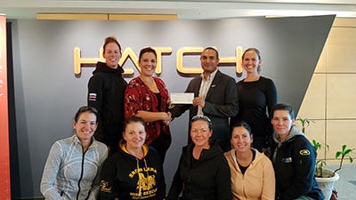Jesal Jani, engineering manager of Hatch's Saskatoon office, presents Diamonds in the Rough with a sponsorship cheque.