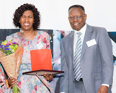 Dr. Trueman Goba, chairman, Hatch Africa, presents the Positive Change Award to Dr. Phuti Mangena.