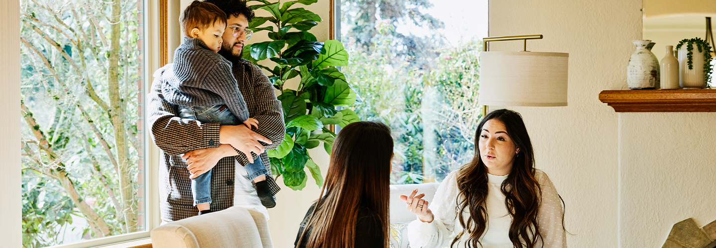 A family is sitting down to discuss a real estate transaction with a realtor.