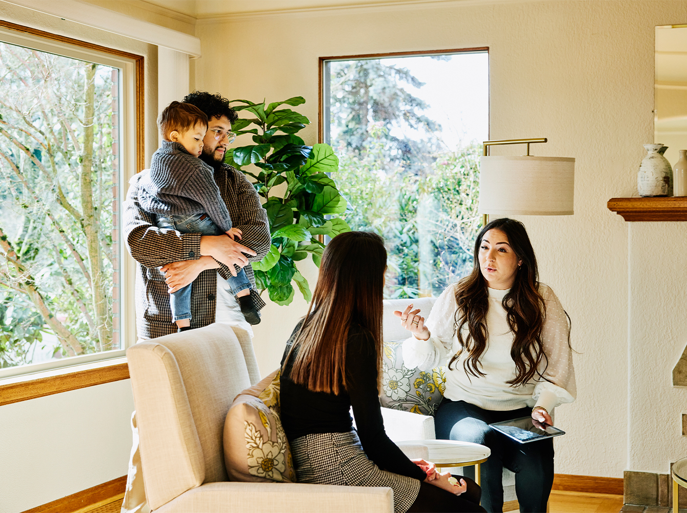 A family is sitting down to discuss a real estate transaction with a realtor.