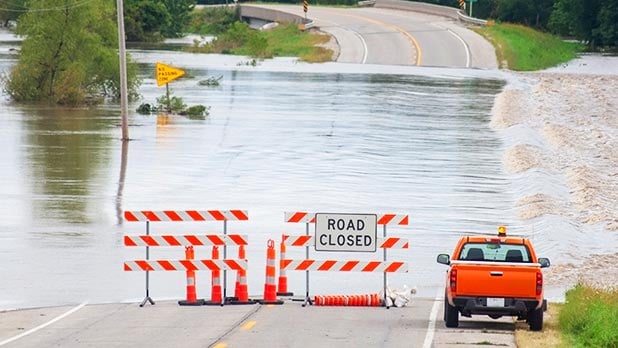 Road closed signs on a flooded road