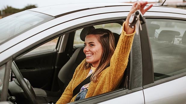Woman sitting in car holding keys