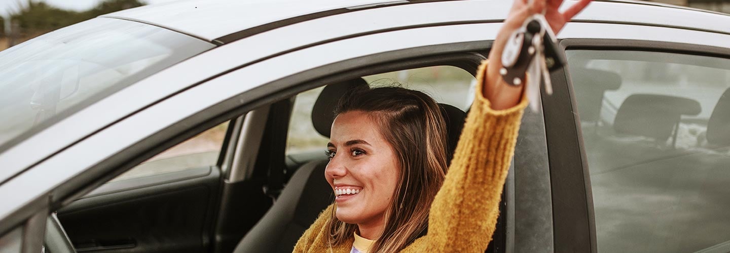 Woman sitting in car holding keys