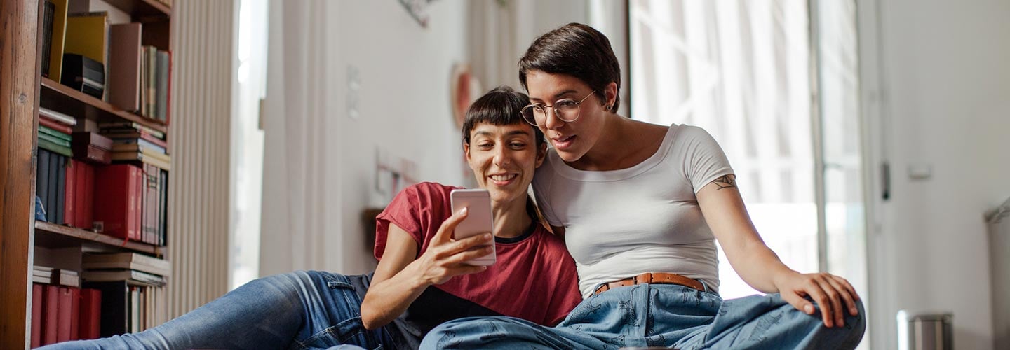 Two women looking at a cell phone