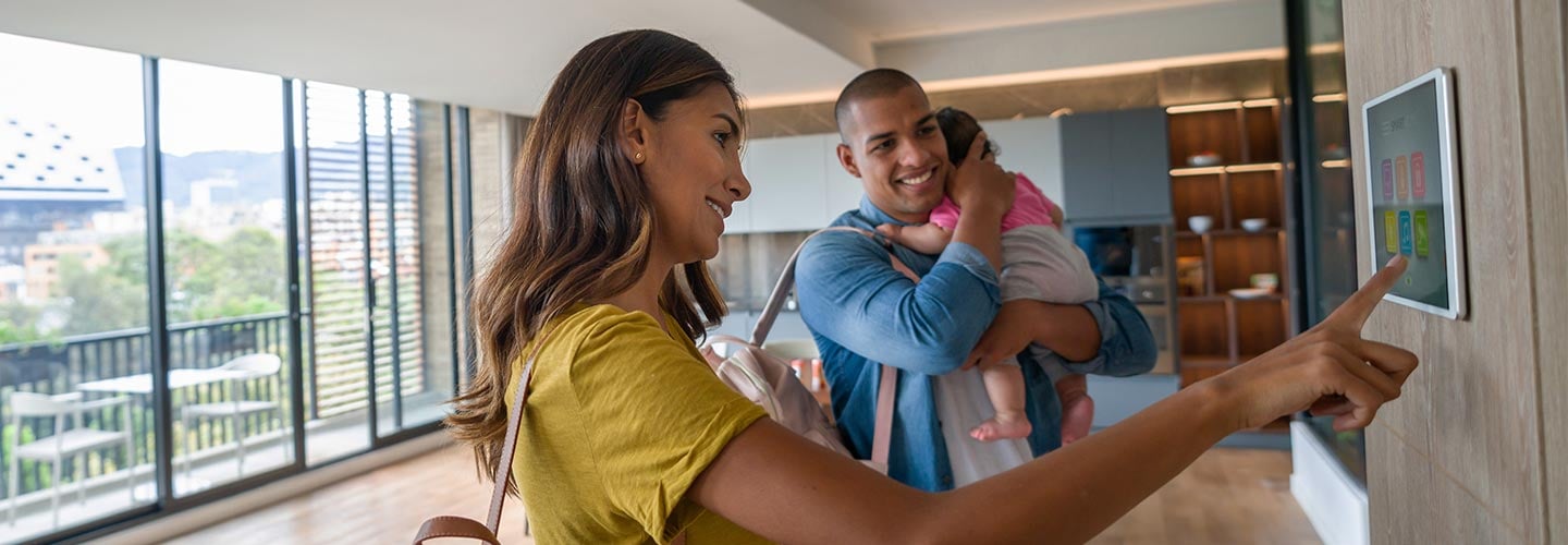 Woman and man with children looking at smart home feature