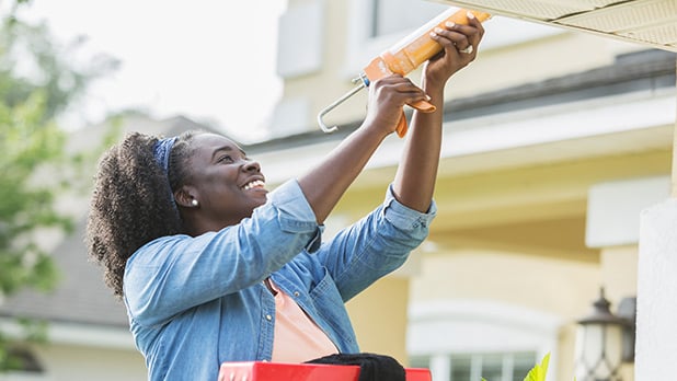 Person sealing their roof