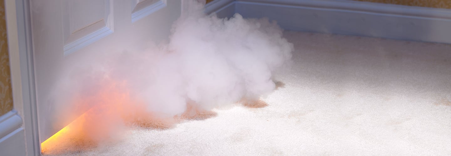 Smoke coming from under a closed door