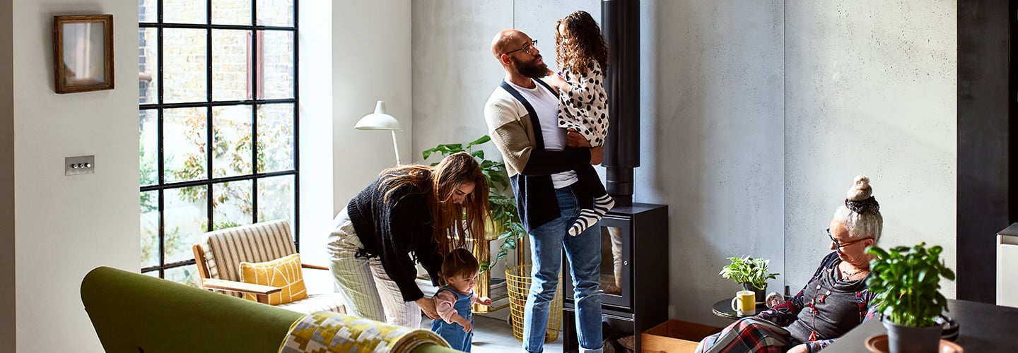 Intergenerational family interacting in a living room