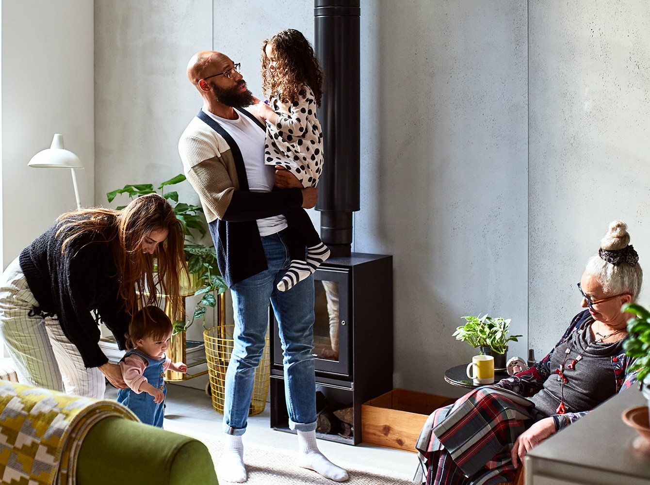 Intergenerational family interacting in a living room