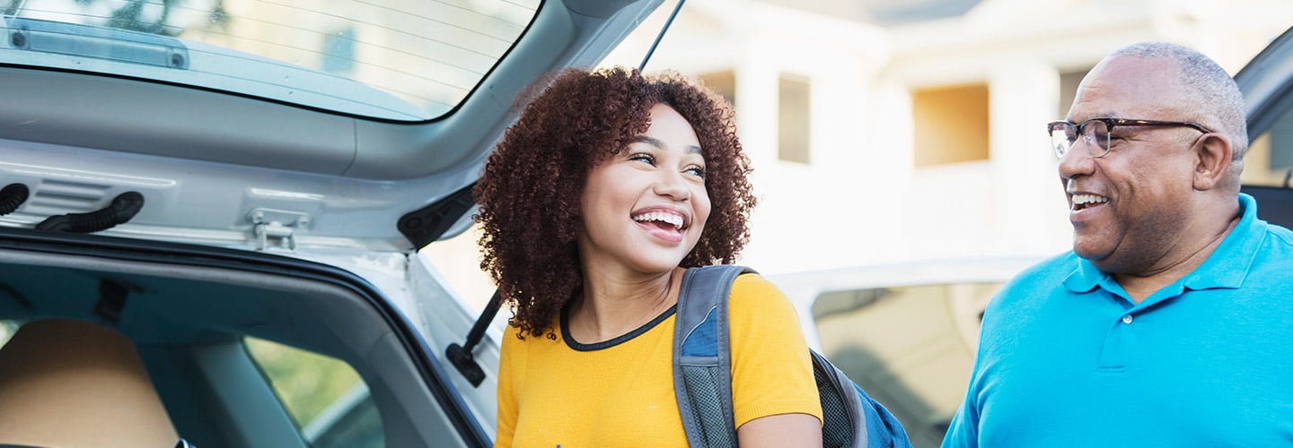 A college student and their parent packing the car to go to college