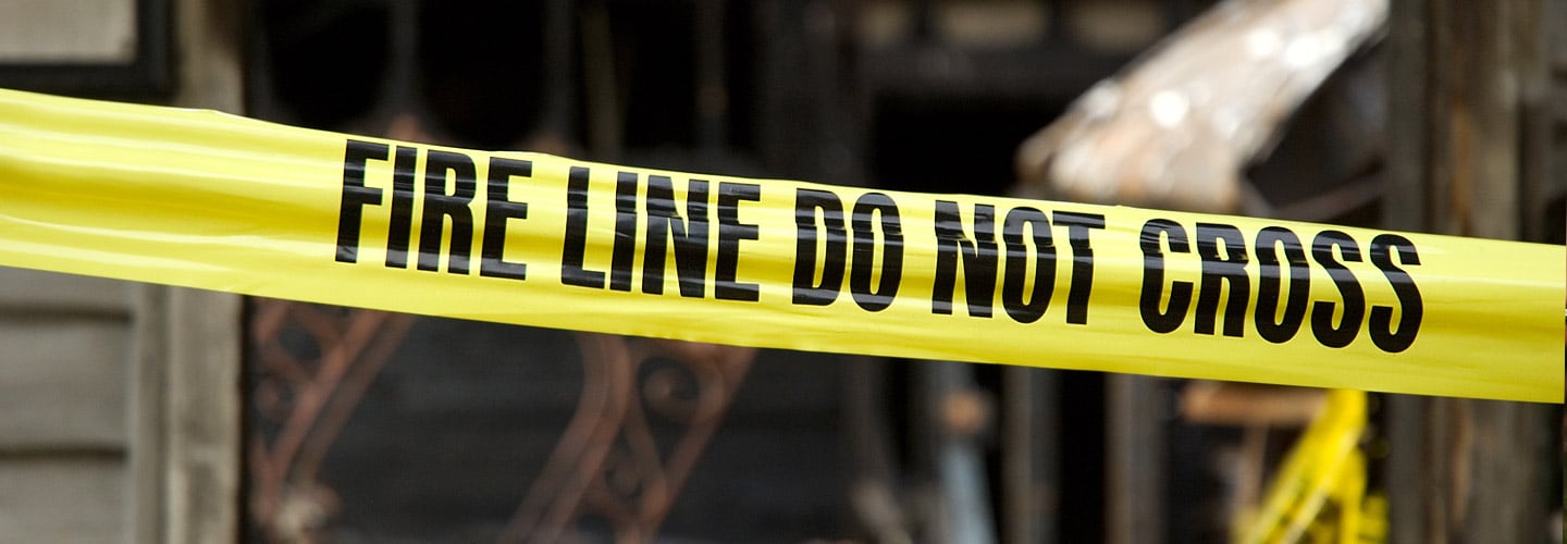 Fire line do not cross tape in front of a house that had a fire