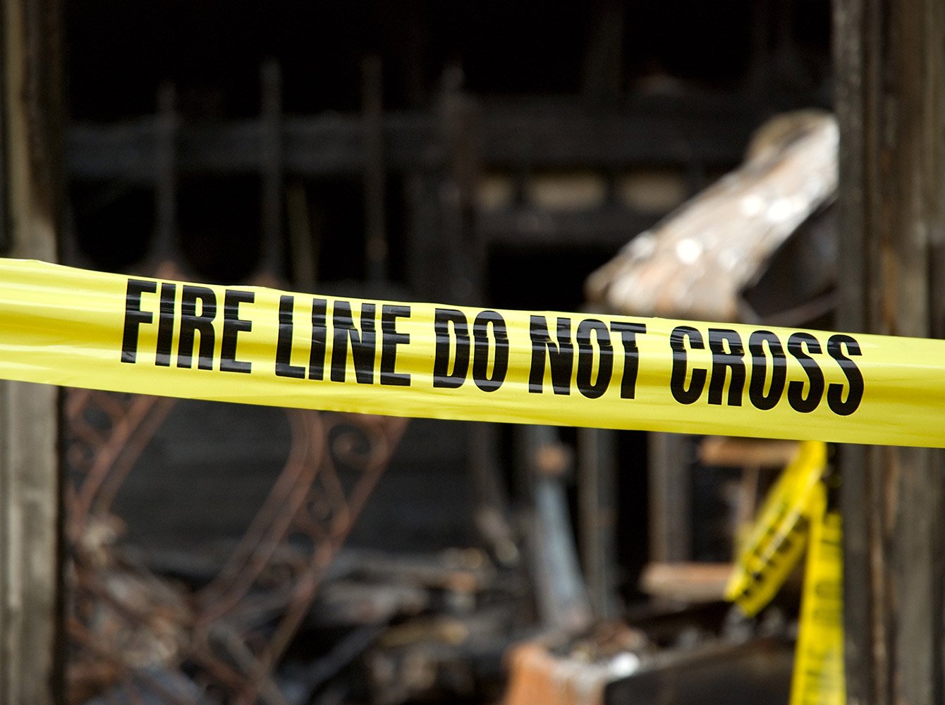Fire line do not cross tape in front of a house that had a fire